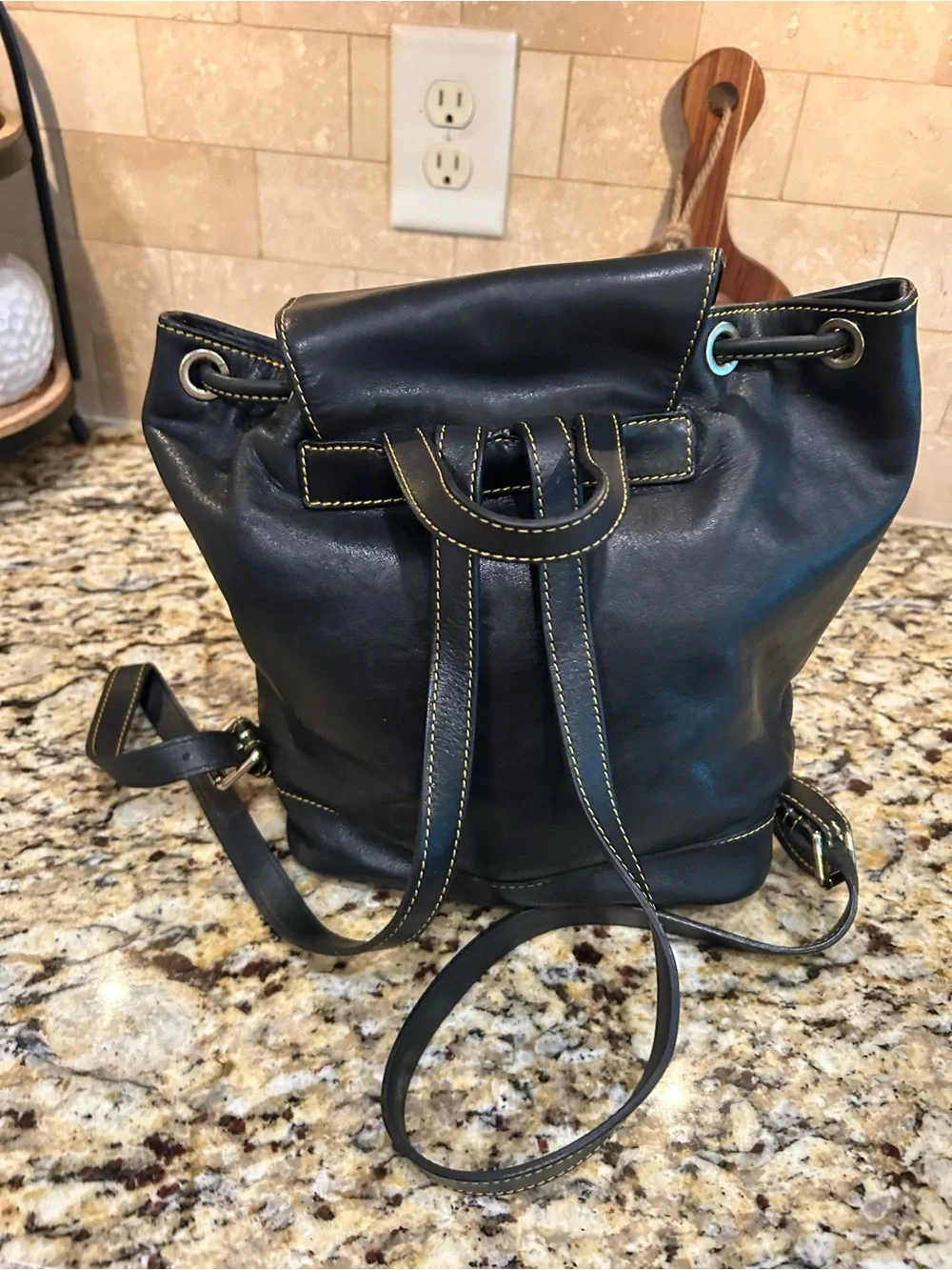 Dooney & Bourke Black Leather Drawstring Backpack with Yellow Stitching